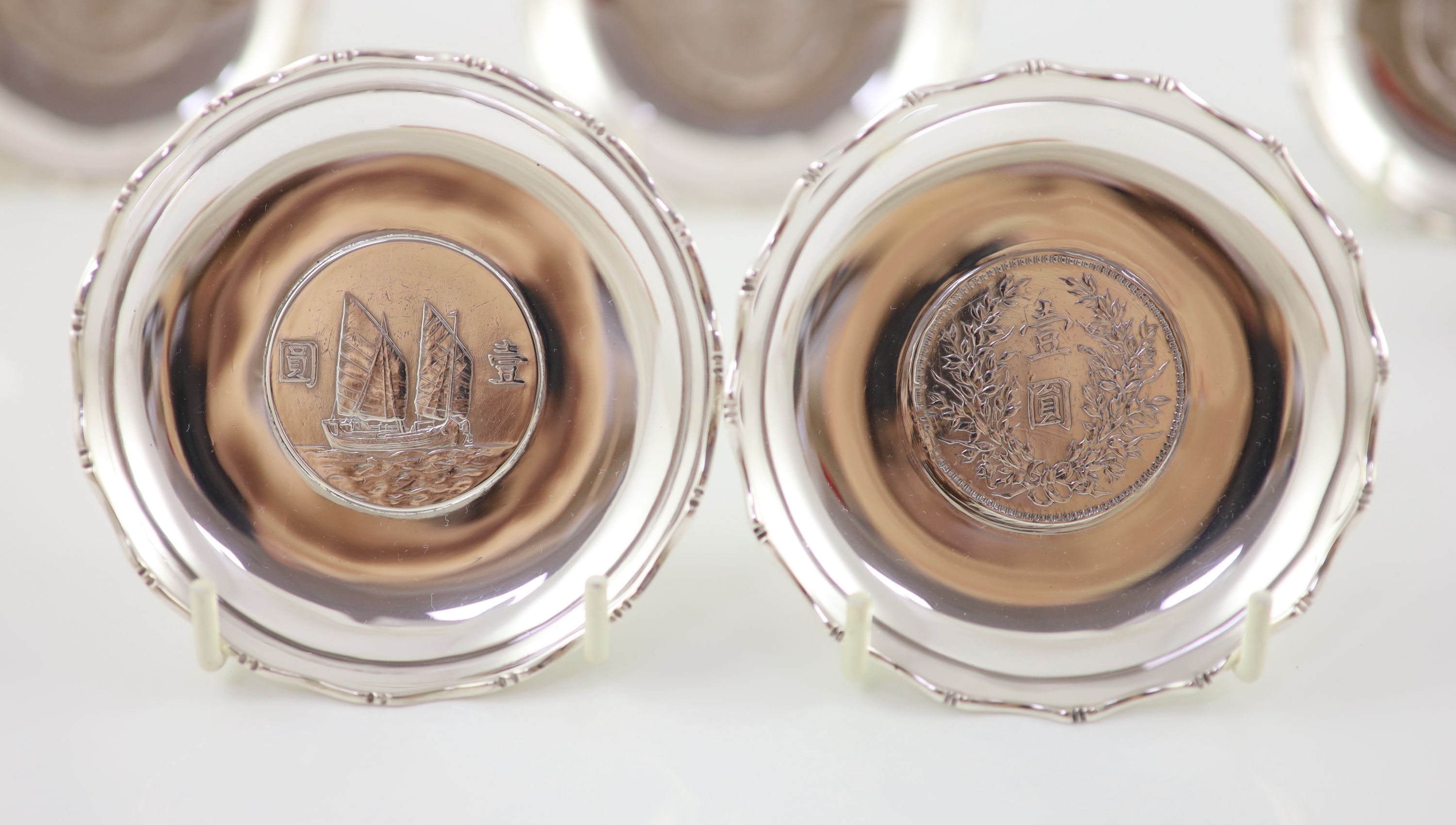 Ten early 20th century Chinese Export small Sterling silver coin inset dishes with shaped 'bamboo' edges, by Tach Hing, Hong Kong,
